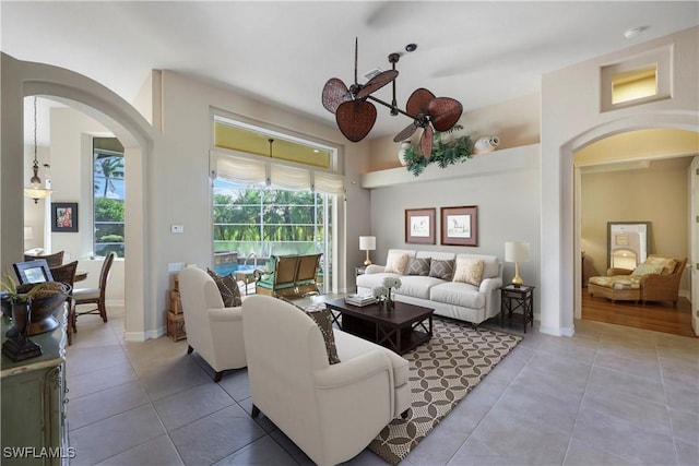 living room featuring tile patterned floors and ceiling fan