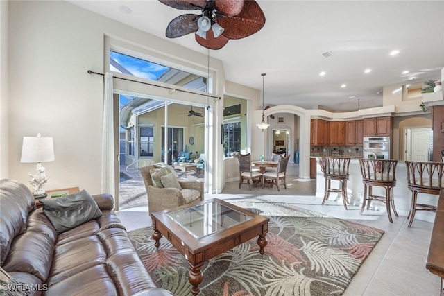 living room featuring ceiling fan and light tile patterned flooring