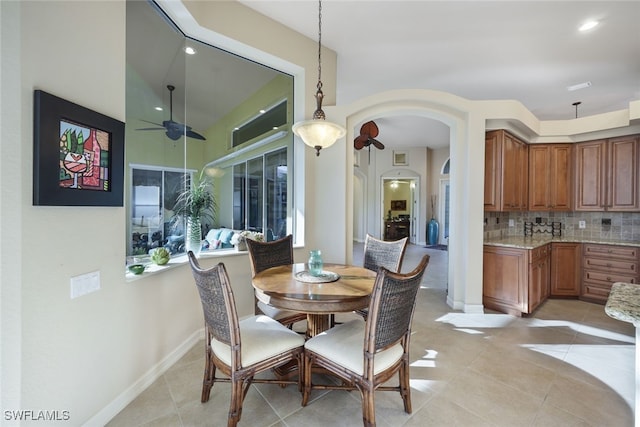 dining area with ceiling fan and light tile patterned floors