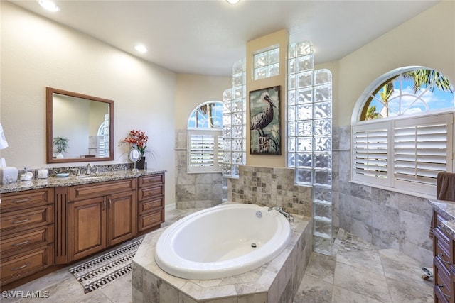 bathroom with plus walk in shower, plenty of natural light, and vanity