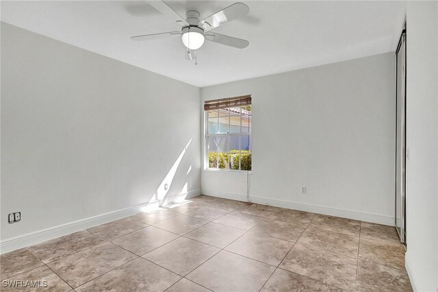 unfurnished room with ceiling fan and light tile patterned floors