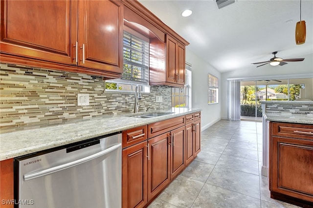 kitchen featuring light stone countertops, dishwasher, ceiling fan, and sink