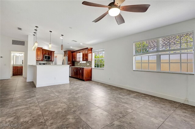 kitchen with ceiling fan, backsplash, decorative light fixtures, light tile patterned flooring, and appliances with stainless steel finishes