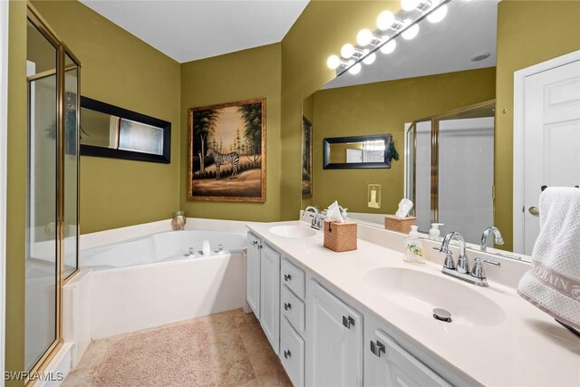 bathroom with vanity and separate shower and tub