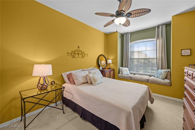 bedroom featuring light colored carpet and ceiling fan