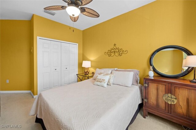 carpeted bedroom with a closet and ceiling fan