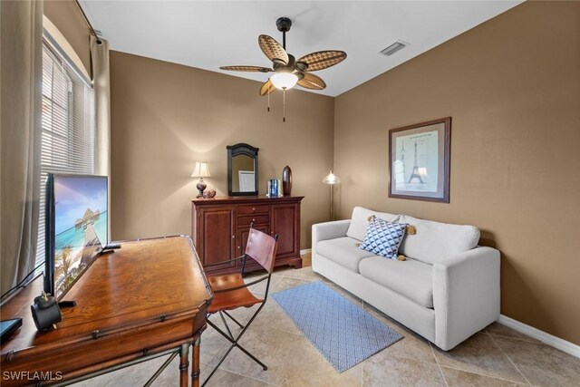 living room with ceiling fan and light tile patterned floors