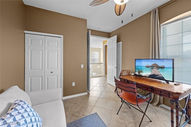 tiled office featuring ceiling fan