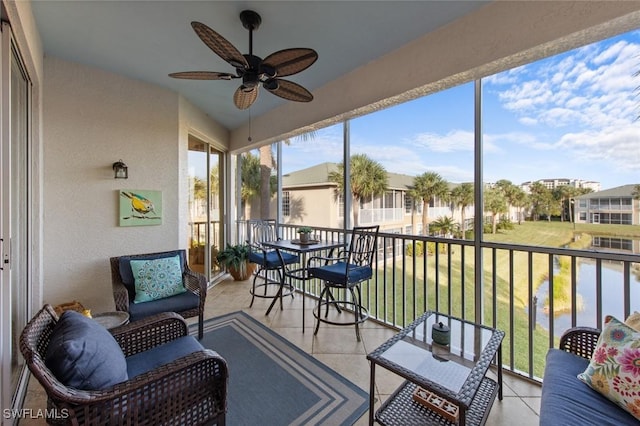 sunroom featuring ceiling fan