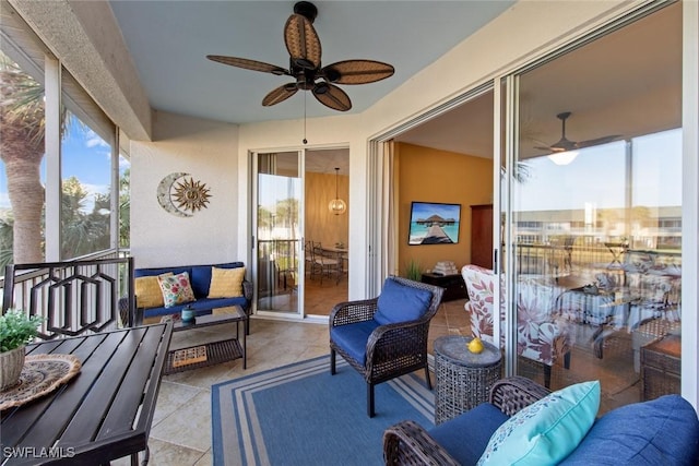 sunroom with a wealth of natural light and ceiling fan