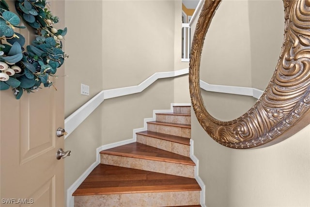 stairway with hardwood / wood-style floors