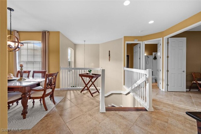 dining area featuring light tile patterned floors and a notable chandelier