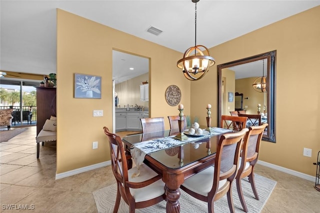 dining room with an inviting chandelier and light tile patterned flooring