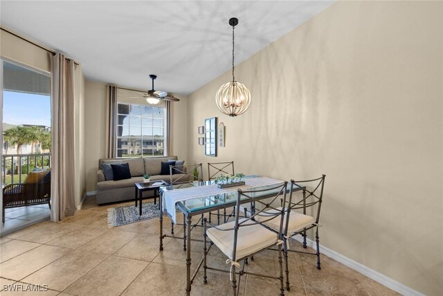 dining room featuring ceiling fan with notable chandelier and light tile patterned flooring