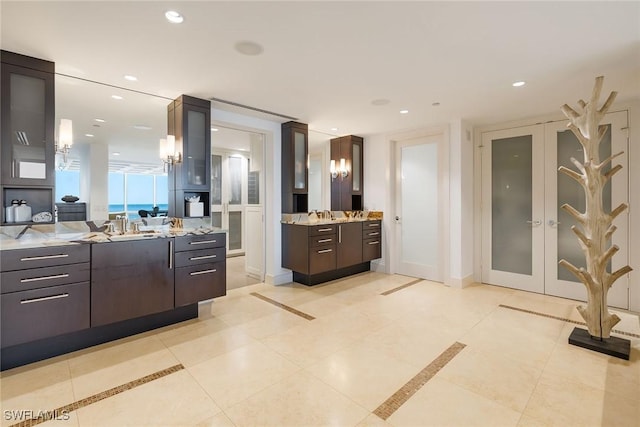 bathroom with vanity, french doors, and tile patterned flooring