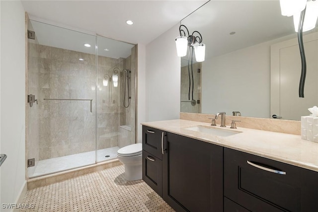 bathroom featuring tile patterned floors, walk in shower, vanity, and toilet