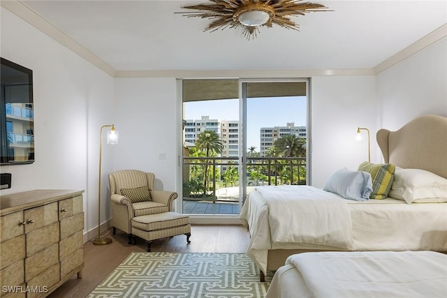 bedroom with ceiling fan, access to exterior, hardwood / wood-style floors, and ornamental molding