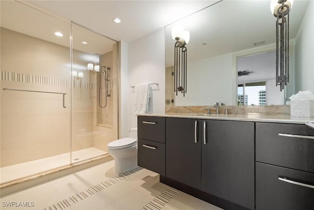 bathroom featuring toilet, vanity, tile patterned floors, and walk in shower