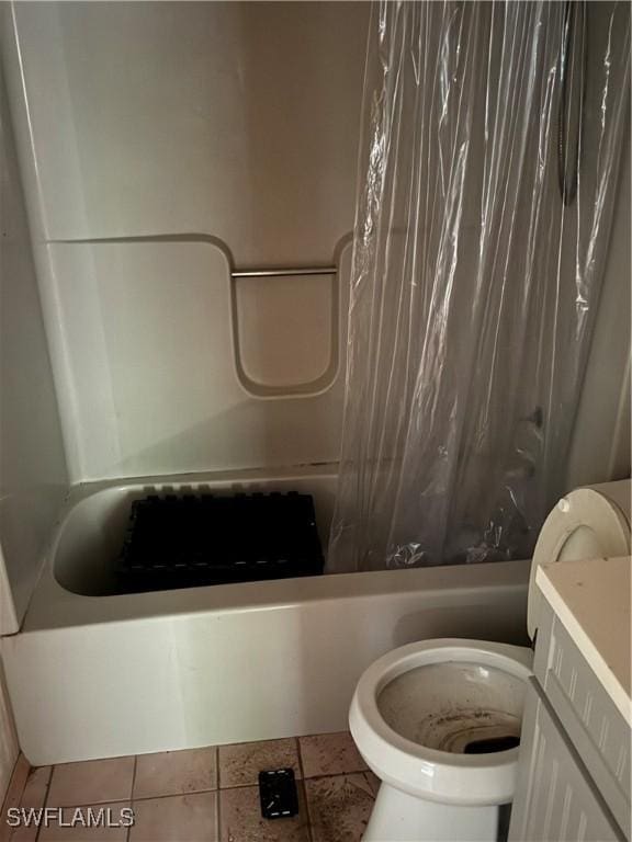 full bathroom featuring tile patterned flooring, shower / bath combination with curtain, vanity, and toilet