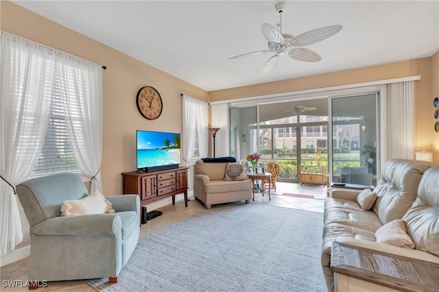 living room featuring ceiling fan, healthy amount of natural light, and light tile patterned floors