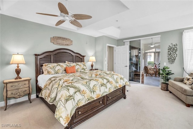 bedroom featuring ceiling fan, a raised ceiling, light carpet, and access to outside