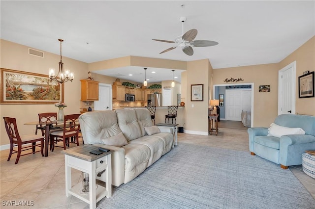 tiled living room featuring ceiling fan with notable chandelier