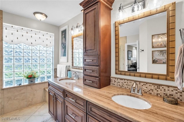 bathroom featuring tile patterned floors, decorative backsplash, and vanity