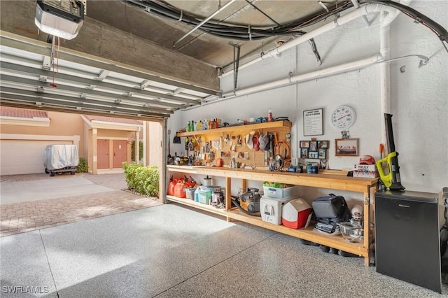 garage featuring a workshop area and a garage door opener