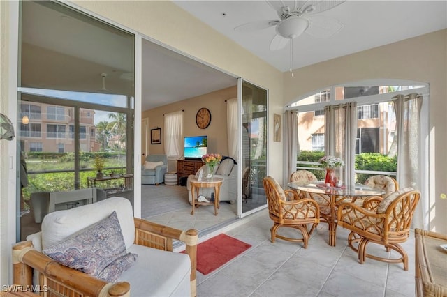 sunroom / solarium featuring ceiling fan