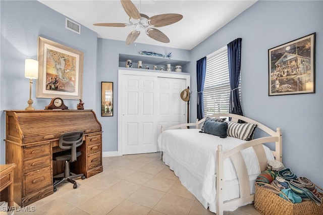 bedroom featuring a closet, ceiling fan, and light tile patterned flooring