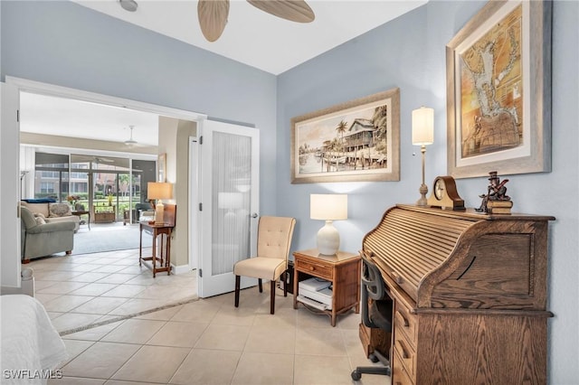 living area with ceiling fan, light tile patterned floors, and french doors