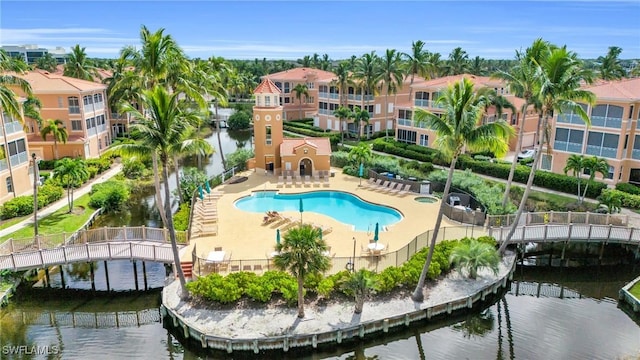 view of pool featuring a patio and a water view