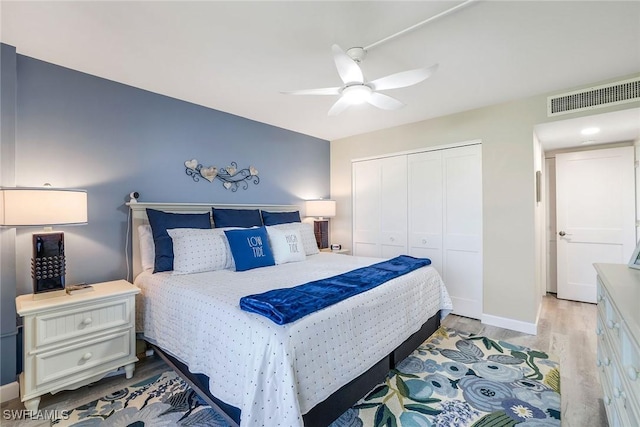 bedroom featuring ceiling fan, a closet, and light hardwood / wood-style floors