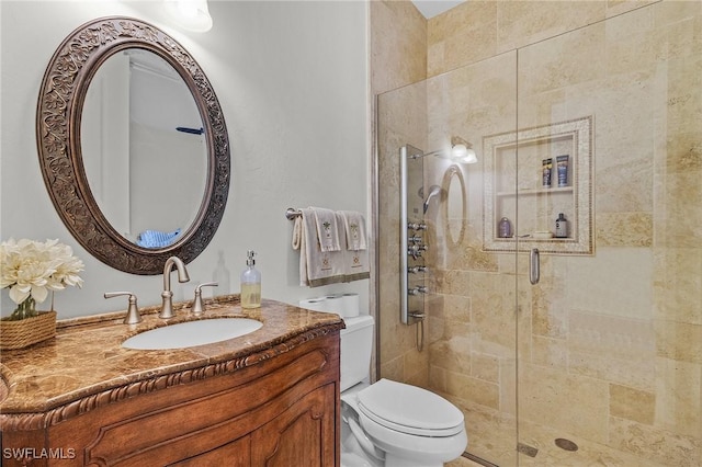 bathroom with vanity, toilet, and walk in shower