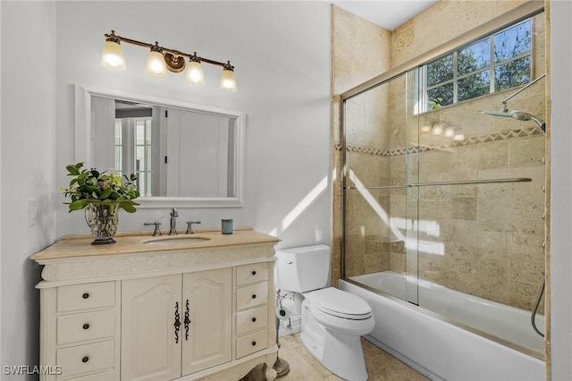 full bathroom featuring combined bath / shower with glass door, tile patterned floors, vanity, and toilet