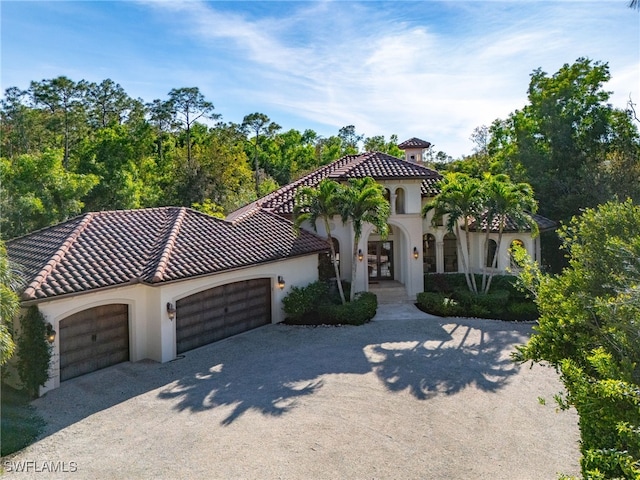 mediterranean / spanish house with a garage