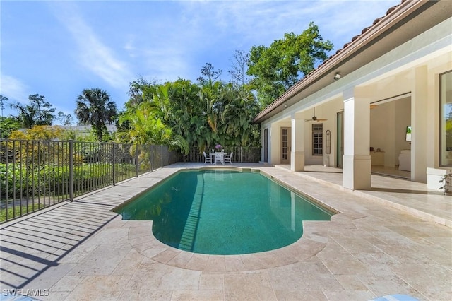 view of swimming pool with ceiling fan and a patio