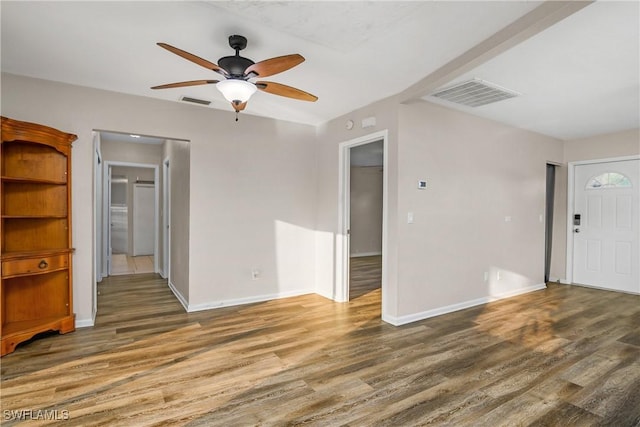 interior space featuring ceiling fan and dark hardwood / wood-style flooring