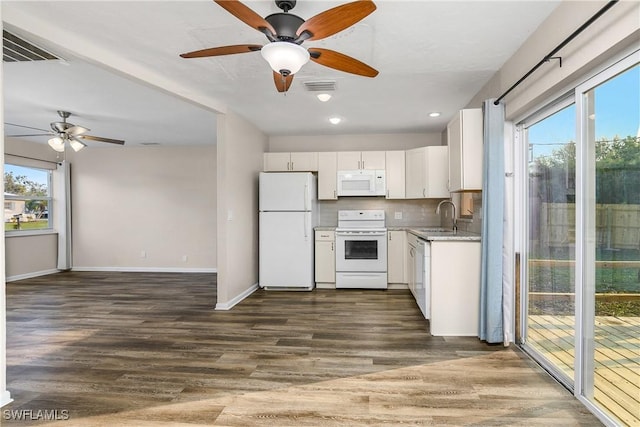 kitchen featuring decorative backsplash, white appliances, dark wood-type flooring, sink, and white cabinetry