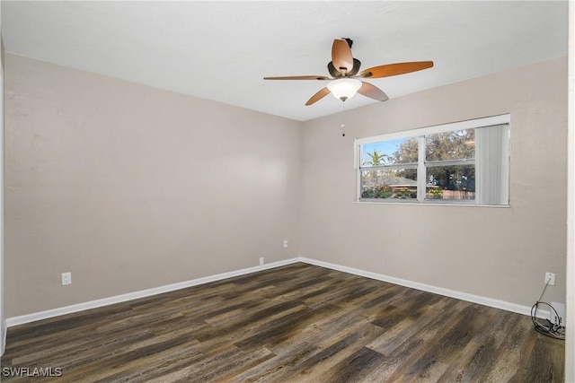 spare room with dark hardwood / wood-style flooring and ceiling fan