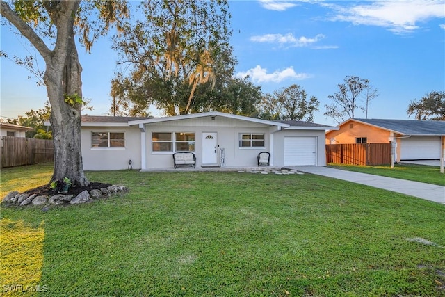 ranch-style home with a front yard and a garage