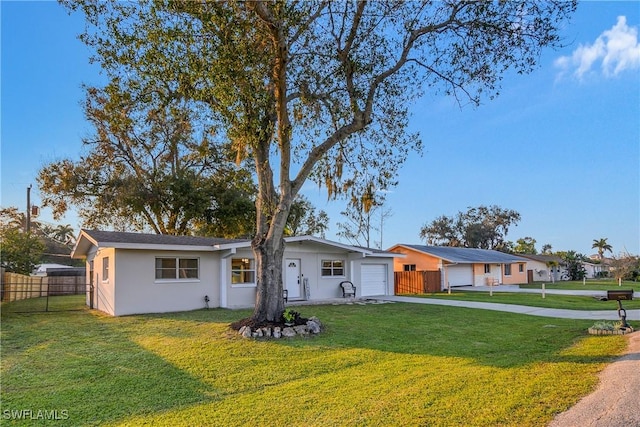 ranch-style house with a front yard and a garage