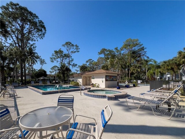 view of swimming pool with a community hot tub and a patio