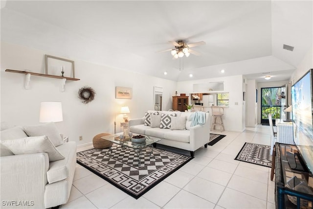 living room featuring lofted ceiling, ceiling fan, and light tile patterned flooring