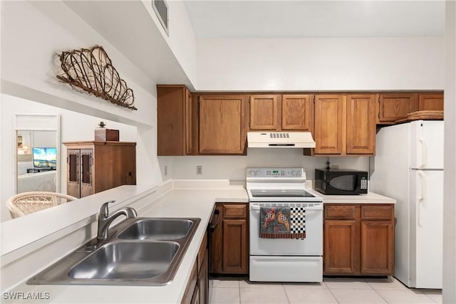 kitchen featuring sink, white appliances, and light tile patterned floors