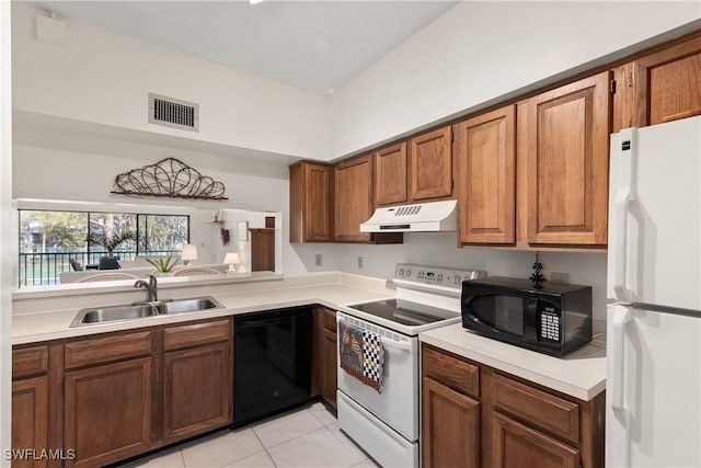 kitchen featuring black appliances, sink, and light tile patterned floors