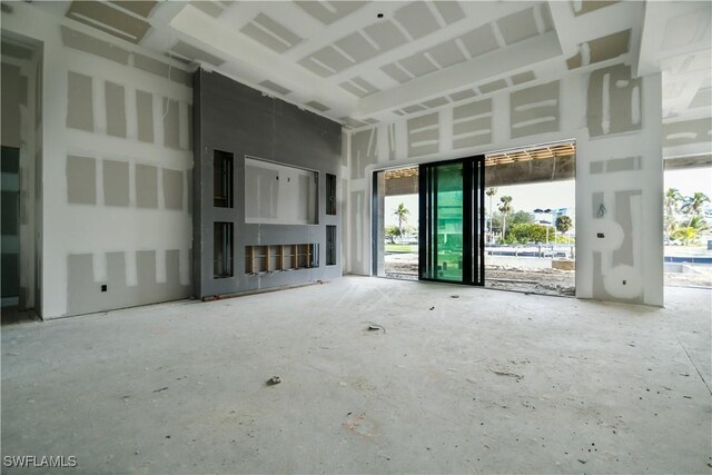 unfurnished living room with a high ceiling