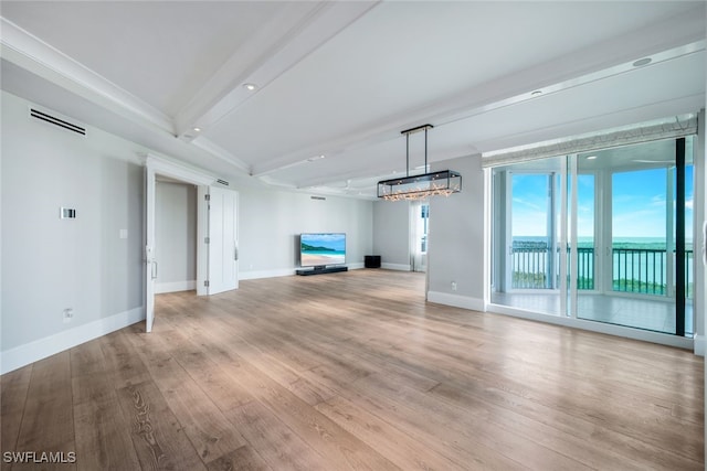 unfurnished living room with beam ceiling and light hardwood / wood-style floors