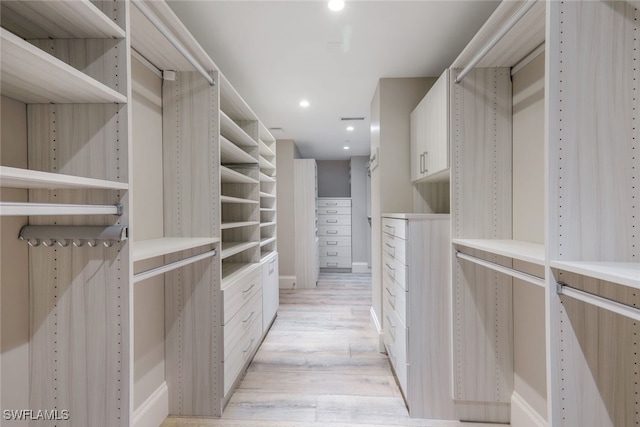 spacious closet featuring light hardwood / wood-style floors