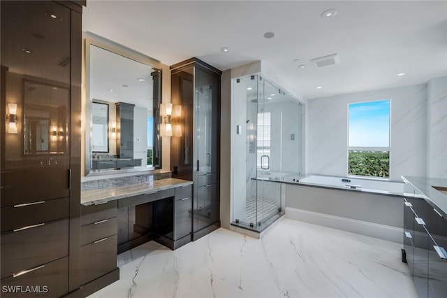 bathroom with vanity and shower with separate bathtub